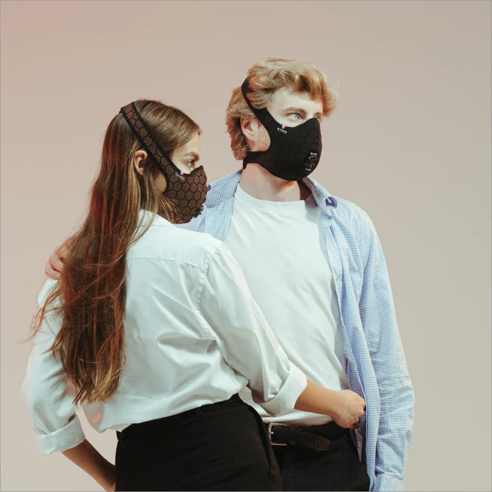Two people in white shirts wearing black R-PUR masks, everyday protection that works well as a travel mask